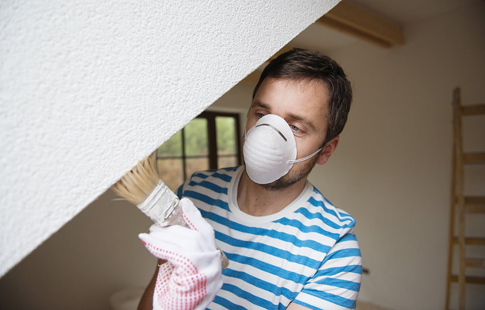 man painting home