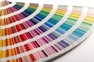 Fan of paint color swatches showing a wide range of vibrant shades.