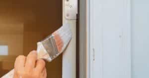 man painting a door 