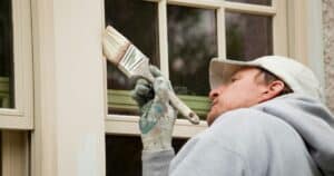 man painting the window