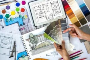 Interior design workspace with floor plans, color swatches, and paint samples