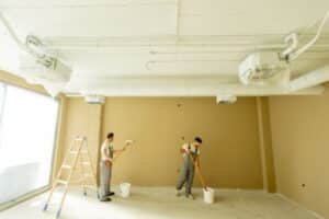two men painting an interior