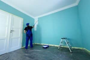 man painting the interior wall