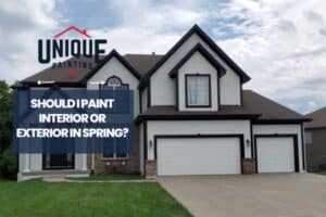 white house painted with a caption Should I Paint Interior or Exterior in Spring?