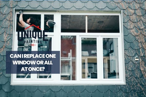 workers installing window with a caption Can I Replace One Window or All at Once?