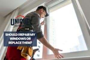 man installing a new window with a caption Should I repair my windows or replace them?