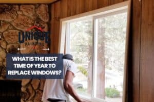 man replacing the windows with a caption What Is the Best Time of Year to Replace Windows?